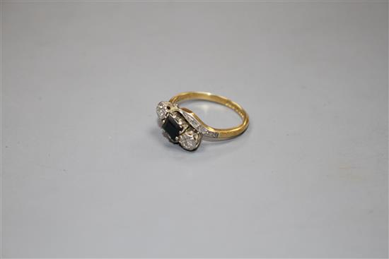 A modern 18ct gold, sapphire and illusion set diamond three stone crossover ring, size L, gross weight 3.5 grams.